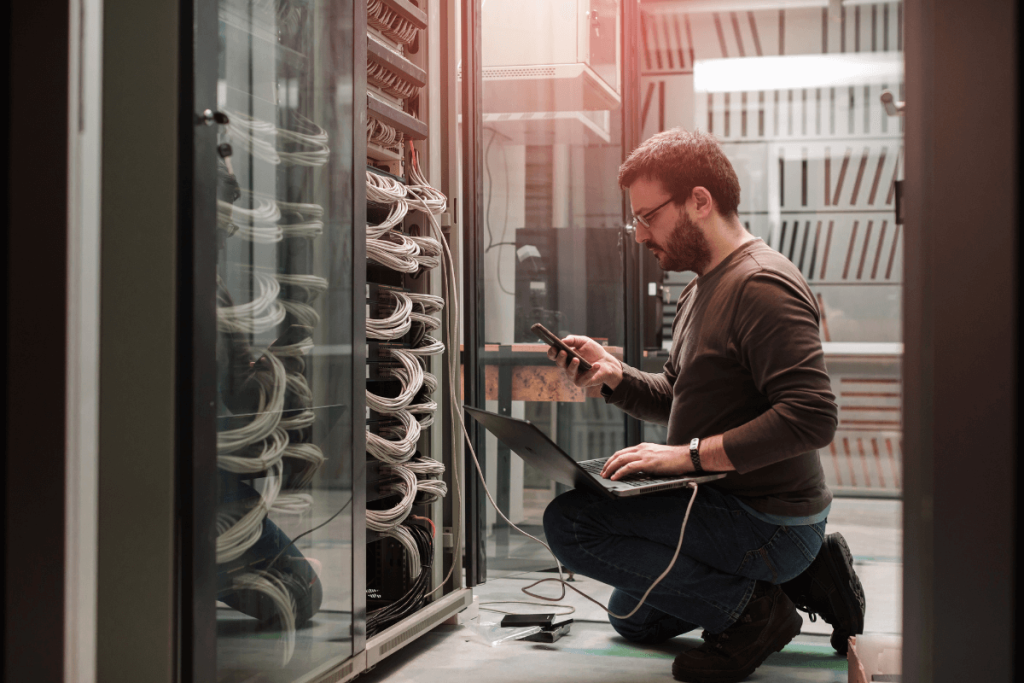 Technicien d’une entreprise informatique Bayonne assurant la maintenance d’un serveur dans un local professionnel.